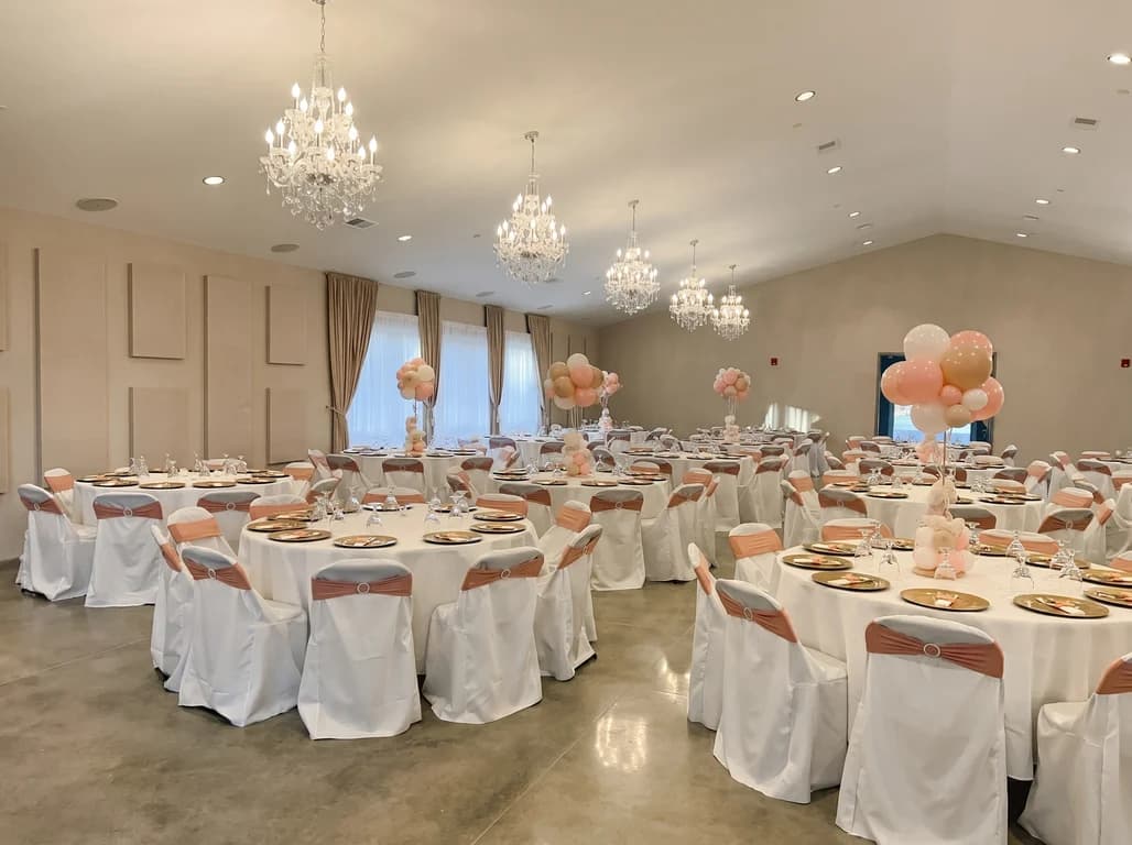 Intimate Gathering package — round tables with rose gold sashes, gold chargers and balloon centerpieces at Fellowship Event Hall